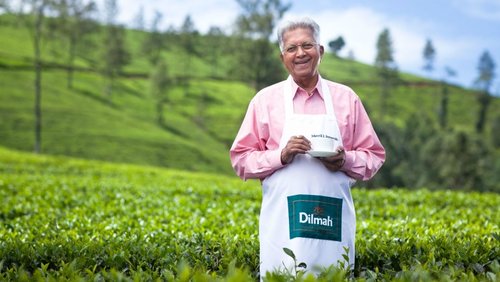 Dilmah founder Merril J. Fernando with a cup of tea in a tea garden
